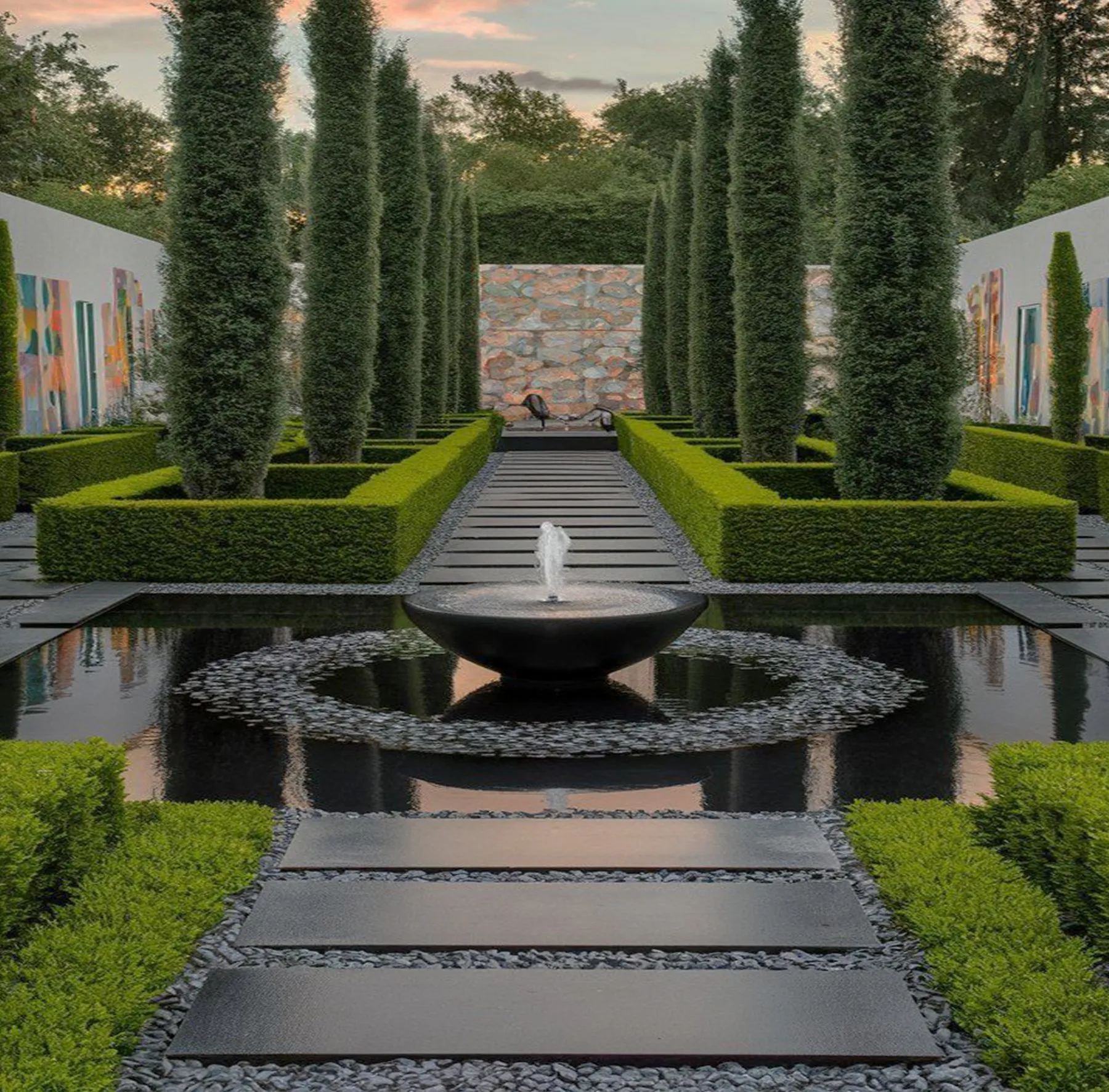 Formal garden with clipped cypress trees, box hedges and a reflecting pool with a fountain